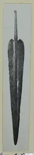 Metal weapon blade with a central ridge, leaf-shaped edges and a narrow tang with a curled end