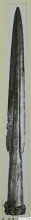 Bronze weapon from Idalion: long tapering blade with a raised midrib and corroded base, shown upright.
