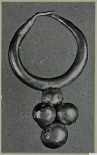 Gold hoop earring with a cluster of four round pendants, from Lapithos