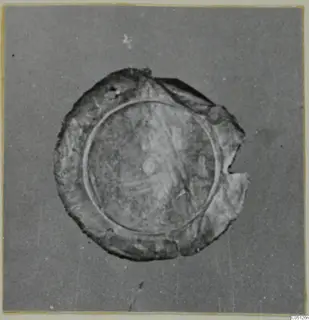 Circular sheet-gold jewellery piece from the Kastros tombs at Lapithos, with a raised ring and broken edge