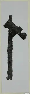 Corroded iron axe with a long shaft, from the Kastros tombs at Lapithos