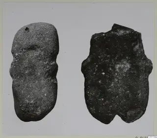 Two stone idols from Petra tou Limniti, photographed against a pale background.