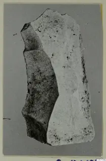Stone chisel from Petra tou Limniti, a flat elongated stone object with broken edges
