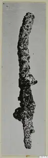 Corroded iron pin from Lapithos, Kastros tombs, shown upright against a pale background