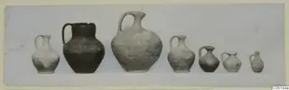 Seven jugs with single loop handles standing in a row, from Tomb 6 at Kountoura Trachonia