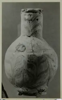 Pot with a tall neck and swirling painted decoration, photographed against a grey backdrop