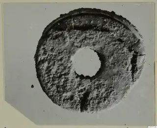 Bone disc with a central hole, find from the Kastros tombs at Lapithos