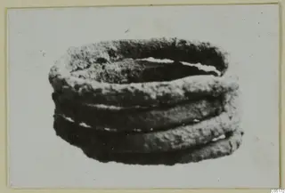 Bronze personal adornment, a coiled band of several turns with a corroded, rough surface