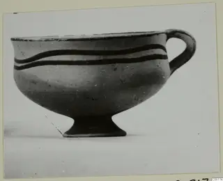 Pottery White Painted I bowl from Lapithos, with a loop handle and two dark horizontal bands on the body