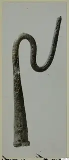 Bronze crook-shaped tool from Lapithos, Kastros tombs, photographed against a plain grey background