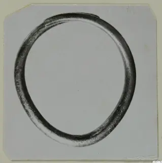 Single dark metal ring with a round cross-section, photographed lying flat on a pale card, from the Ayios Iakovos finds
