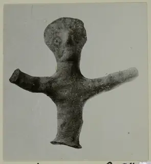 Small terracotta figurine of a standing human figure with outstretched arms and a rounded head.