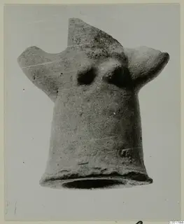 Terracotta Minor Plastic 3 from Ayios Iakovos: hollow clay figure with a flared base and two projections, against grey.