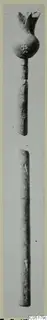 Long bronze pin shown in two pieces, the upper with a knobbed head and flared tip, the lower a plain shaft