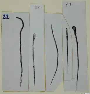 Five thin dark metal pins or rods from Ayios Iakovos Tomb 8, each on its own card strip