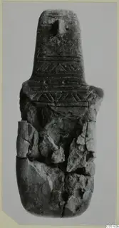Idol, a broken object with a tapering neck and bands of incised chevrons and lines