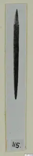 Pin from the Vrysi tou Barba tombs at Lapithos, shown dark against a pale background