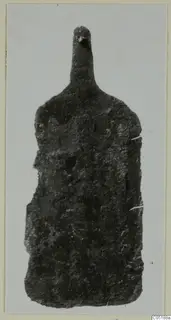 Corroded bronze object from Lapithos Tomb 302A, shown as a mounted photograph.