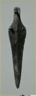 Long pointed bronze object from Lapithos Tomb 302A, tapering to a point, shown against a grey card.