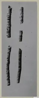 Five corroded tubular bronze objects from Lapithos, Vrysi tou Barba tombs, photographed on grey card