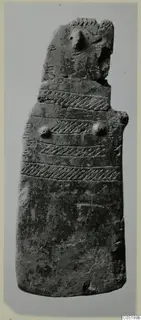 Idol from Lapithos: a flat upright clay figure with a pointed head and incised diagonal bands across the body
