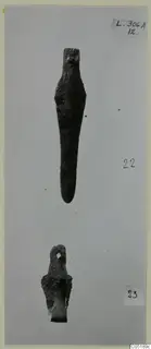 Two bronze tools from Lapithos, tomb L. 306 A, photographed against a grey background.