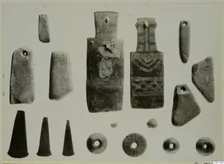 Small finds from Lapithos Tomb 313 A: two large incised flat figurines, stone axe-like tools, dark cones and ring-shaped beads
