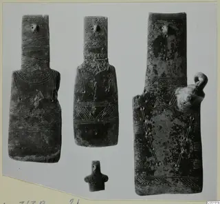 Three flat idols and a small figurine from Lapithos Tomb 313 B, incised with bands and zigzag patterns