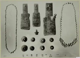 Small finds from Lapithos Tomb 313 B: three flat idols, a small figurine, two bead necklaces and eight round pierced objects.