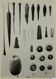 Bronze tools, weapons and small finds from Lapithos Tomb 315 A, laid out in rows on a pale background