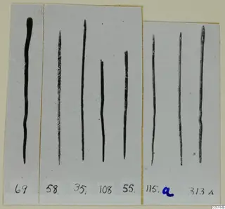 Eight long, thin metal rods on grey card mounts, numbered with labels, from Lapithos Tomb 313 A.