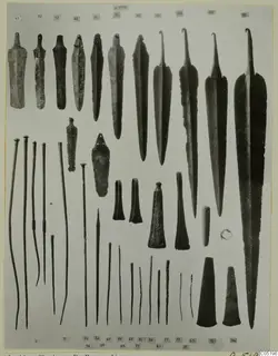 Metal weapons, tools and pins from Lapithos Tomb 313 B, laid out in rows and numbered with grey labels