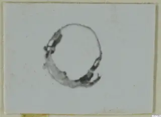 Ring-shaped metal object from Lapithos Tomb 313 B, photographed on a white card
