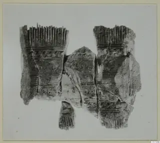 Fragments of carved bone objects from Enkomi Tomb 16, with comb-like teeth along their upper edges