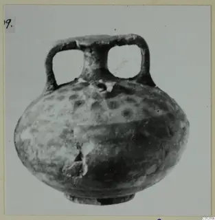 Round-bodied vessel with two loop handles and dark spots on its body, from Enkomi Tomb 3