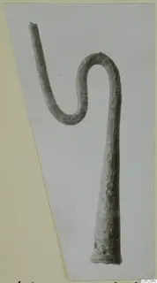 Corroded metal rod bent into an S-curve, from Lapithos Tomb 409