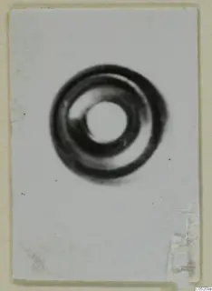 Coiled ring-shaped object from Enkomi, Tomb 3, centred on a white card mount