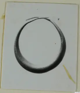 Ring-shaped object from Enkomi, Tomb 3, shown in a photograph mounted on a card