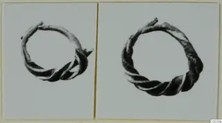 Two photographs of twisted wire rings from Enkomi, Tomb 3, shown side by side on a mount