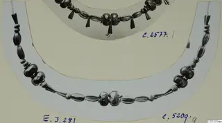 Two necklaces of metal beads and tapered pendants, each photographed on a mounted card, from Enkomi Tomb 3