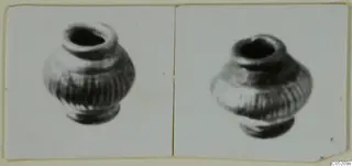 Two views of a small ribbed vessel with a narrow mouth, from Enkomi Tomb 3, mounted side by side on a card