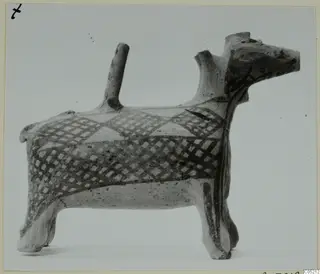 Animal-shaped pottery vessel with a dark painted lattice and triangle pattern, from the Lapithos Kastros tombs