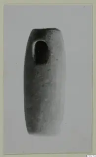 Cylindrical stone object with a large oval perforation near its upper end
