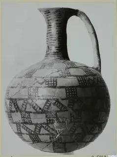 Painted jug with a tall neck, strap handle and dark cross-hatched bands on a pale body, from Ayios Iakovos