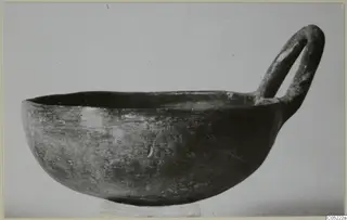 Black Slip Ware bowl with a single loop handle, shown in side view