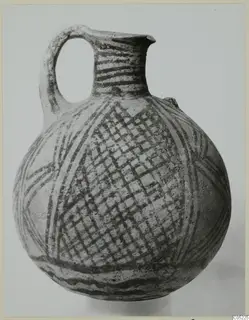 White Painted pottery jug with a looped handle and dark painted bands and cross-hatching on a pale body