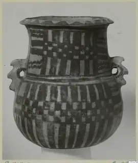 Pottery White Painted III-2 jar with two handles and painted bands, photographed against a pale backdrop