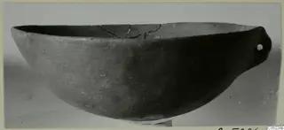 Pottery Red Polished IV bowl with a pierced lug handle, seen from the side, from the Vrysi tou Barba tombs at Lapithos