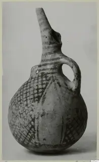 Pottery White Painted III-2 vessel with a tall spout, a single loop handle and a dark painted lattice design