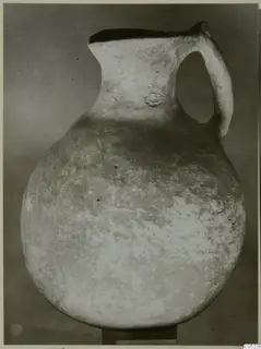 Pottery jug with a globular body, tall neck and strap handle, from the Vrysi tou Barba tombs at Lapithos